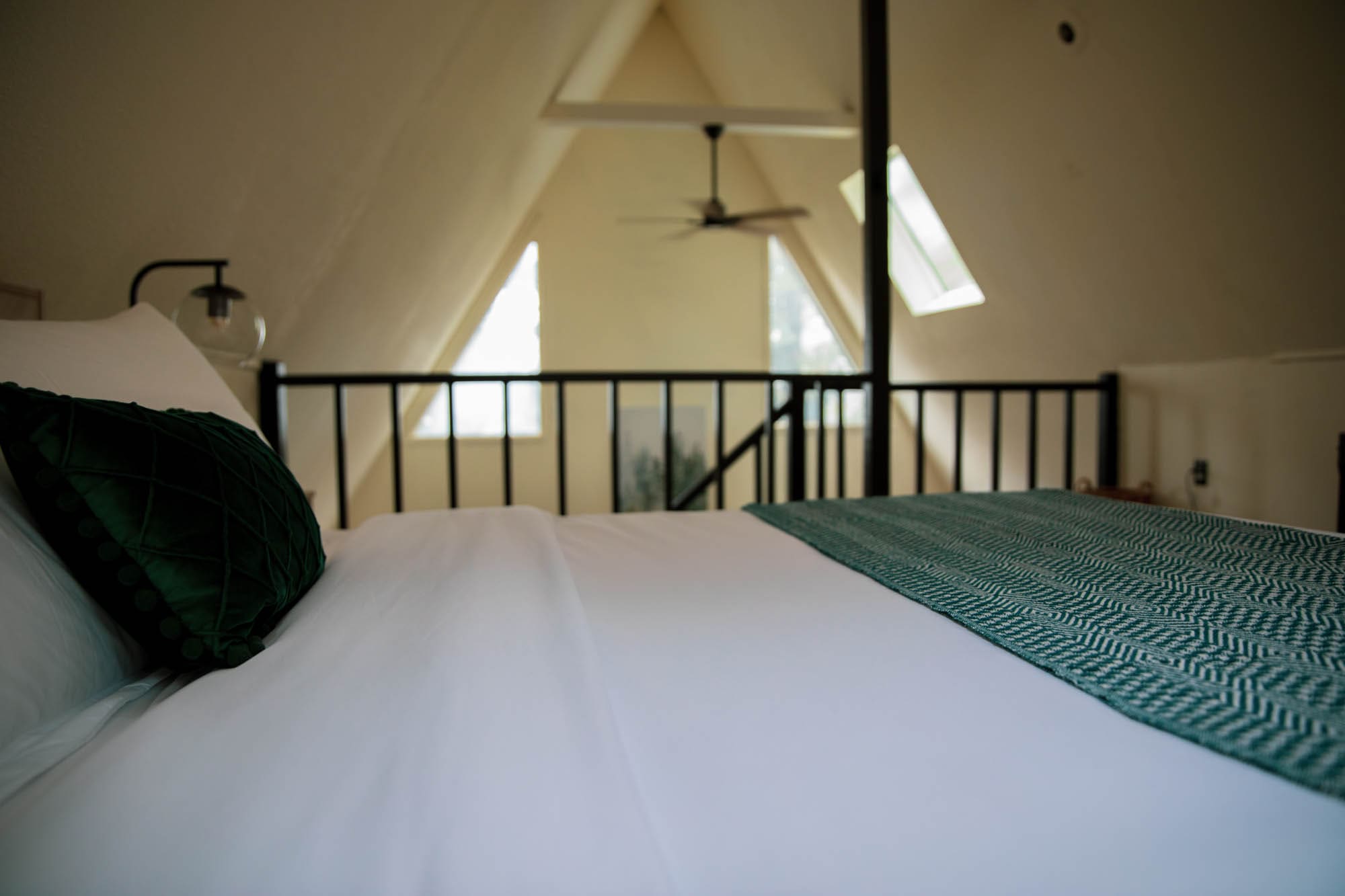 Vaulted A-frame ceiling and skylights above the loft at this Poconos A-Frame cabin